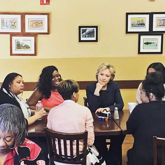 Hillary Clinton speaks with Latoya Holman and other women.