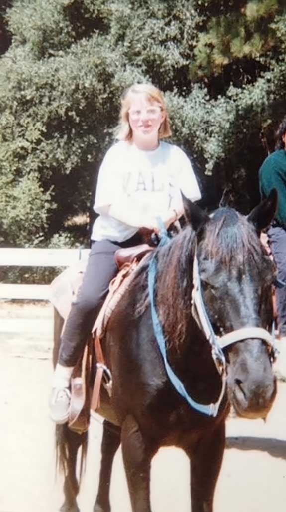Karen Karen riding a horse at camp.