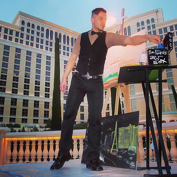 Nick San Pedro painting live on canvas for a private party, poolside at Bellagio. Photo by Mackenzie Claude.