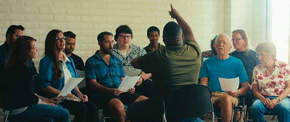Jason Cooper (Anthony Bawn) directs the community center's choir